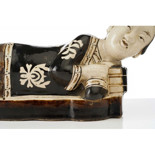 160 - A Chinese Cizhou figural pillow, Song dynasty or later, modelled as a recumbent female, wearing a bl... 