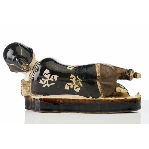 160 - A Chinese Cizhou figural pillow, Song dynasty or later, modelled as a recumbent female, wearing a bl... 