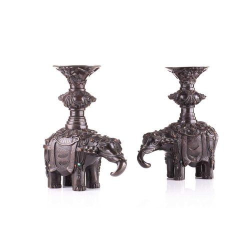 181 - A pair of Chinese bronze caparisoned elephants, Qing, 19th century, supporting a Gu vase upon its ba... 