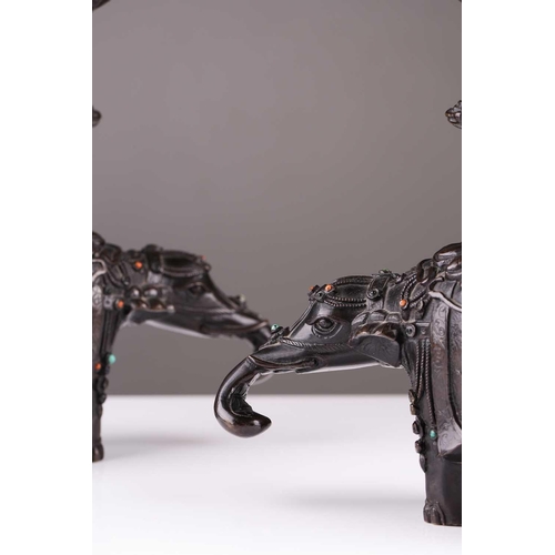 181 - A pair of Chinese bronze caparisoned elephants, Qing, 19th century, supporting a Gu vase upon its ba... 