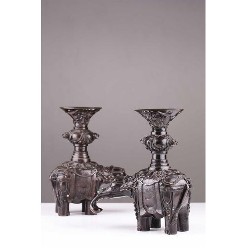 181 - A pair of Chinese bronze caparisoned elephants, Qing, 19th century, supporting a Gu vase upon its ba... 