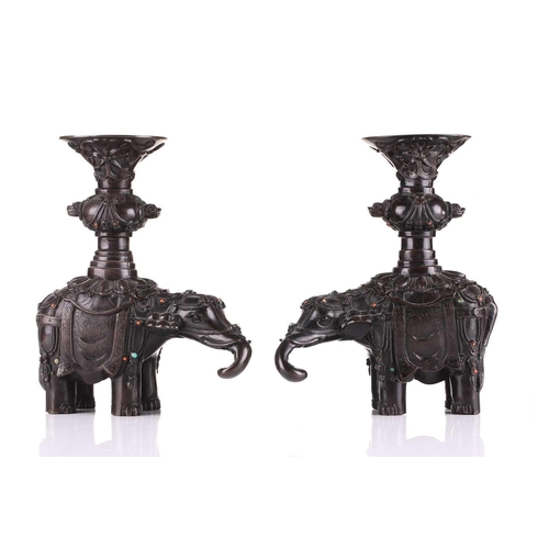 181 - A pair of Chinese bronze caparisoned elephants, Qing, 19th century, supporting a Gu vase upon its ba... 