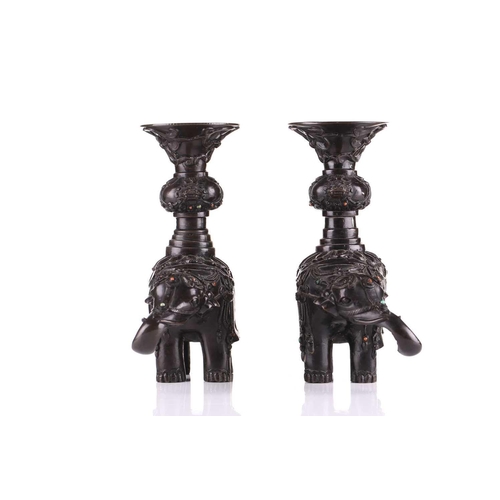 181 - A pair of Chinese bronze caparisoned elephants, Qing, 19th century, supporting a Gu vase upon its ba... 