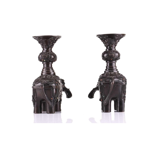 181 - A pair of Chinese bronze caparisoned elephants, Qing, 19th century, supporting a Gu vase upon its ba... 