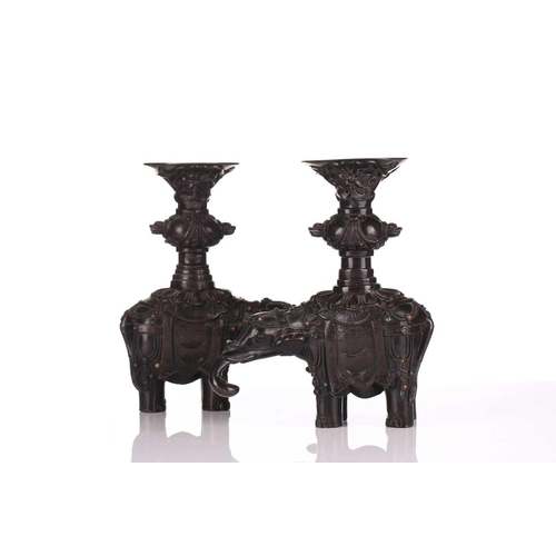 181 - A pair of Chinese bronze caparisoned elephants, Qing, 19th century, supporting a Gu vase upon its ba... 