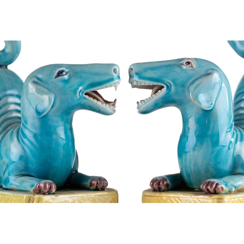 184 - A pair of Chinese torquoise glazed dogs, Qing 19th century, modelled baying with open mouth showing ... 