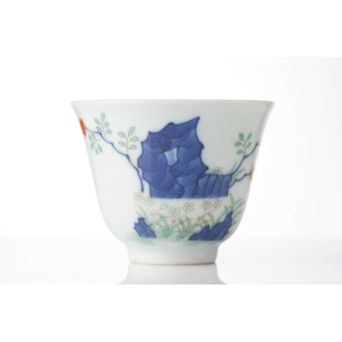 200 - A Chinese porcelain wine cup, painted with blossoming plants and rockwork, six character Guangxu mar... 