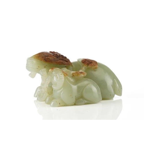 201 - A Chinese jade figure of a ram and its young, in a recumbent pose, each sharing a single stem of lin... 