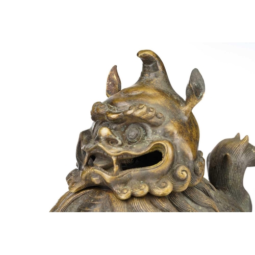 75 - A large Chinese bronze Pixiu censor, with open mouth, scrolling mane and eyebrows, the ears pricked,... 