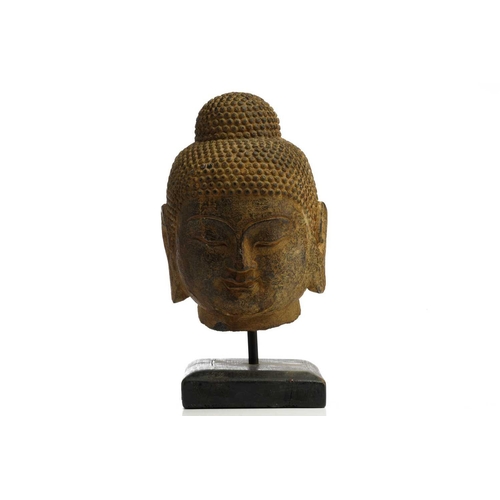 85 - A Chinese-carved stone head of the Gautama Buddha with finely curled hair to the ushnisha and eyes c... 