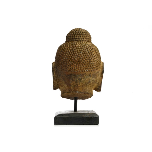 85 - A Chinese-carved stone head of the Gautama Buddha with finely curled hair to the ushnisha and eyes c... 