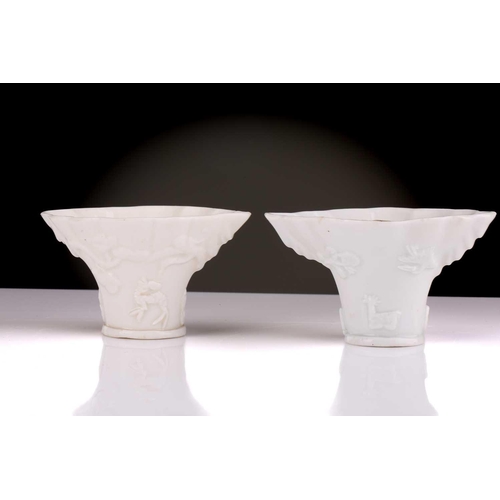 86 - Two Chinese Dehua blanc de chine libation cups, Qing, 18th century, each with applied dragon above a... 