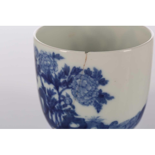 87 - A Chinese blue & white chicken cup, Qing, painted with a boy and chicken between rocks and blossomin... 