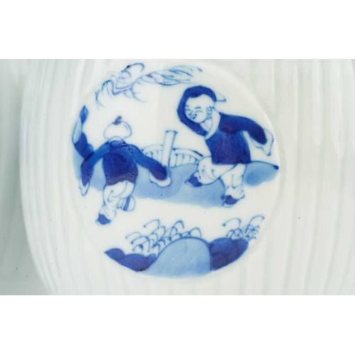 88 - A pair of Chinese blue & white barrel shape vases, with round panels depicting boys at play, against... 