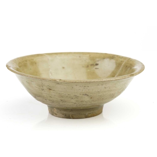 91 - A Chinese Longquan celadon bowl, Song - Yuan dynasty, of shallow conical form, with flower head deco... 