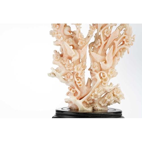 94 - A Chinese mottled pink/white coral carving in the form of a flowering prunus tree, 20th century, wit... 