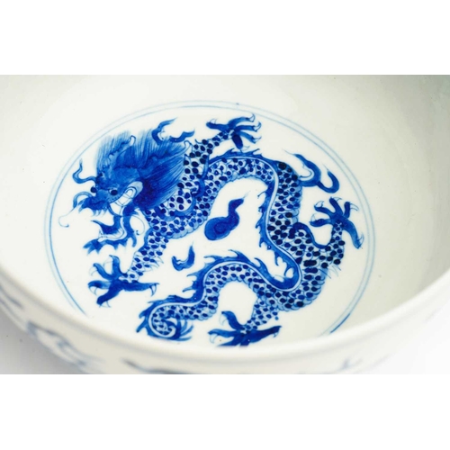 95 - A Chinese porcelain blue & white dragon bowl, the interior with a single writhing dragon, the exteri... 