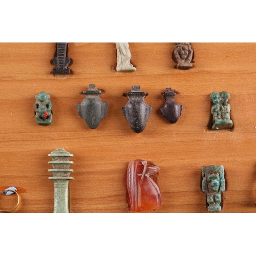 99 - A Collection of Ancient Egyptian artefacts including a bronze Djed pillar amulet, agate Tawaret amul... 