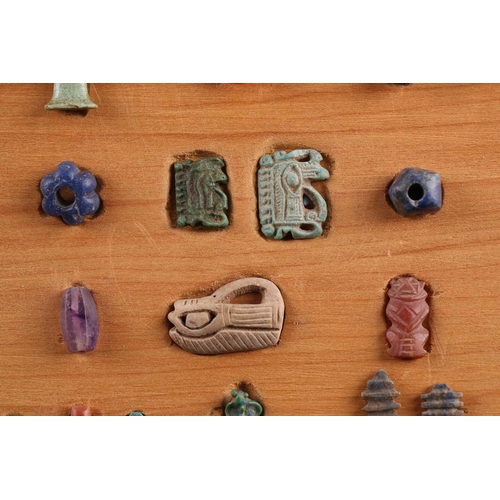 99 - A Collection of Ancient Egyptian artefacts including a bronze Djed pillar amulet, agate Tawaret amul... 