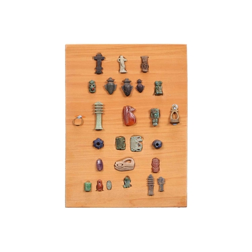 99 - A Collection of Ancient Egyptian artefacts including a bronze Djed pillar amulet, agate Tawaret amul... 