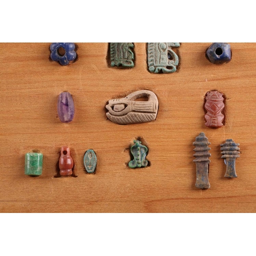 99 - A Collection of Ancient Egyptian artefacts including a bronze Djed pillar amulet, agate Tawaret amul... 