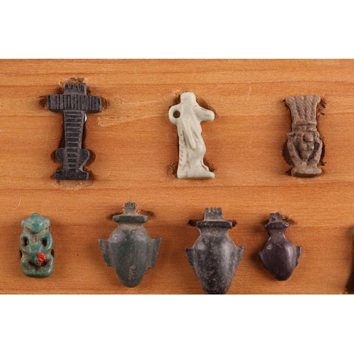 99 - A Collection of Ancient Egyptian artefacts including a bronze Djed pillar amulet, agate Tawaret amul... 