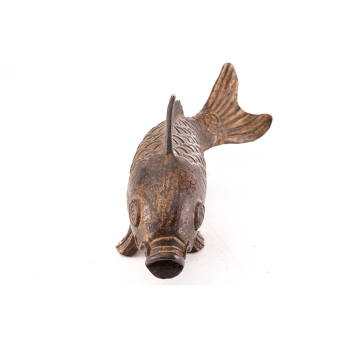 131 - A Chinese bronze carp, the scaley body supported by the pelvis and anal fins, parcel gilt with trace... 