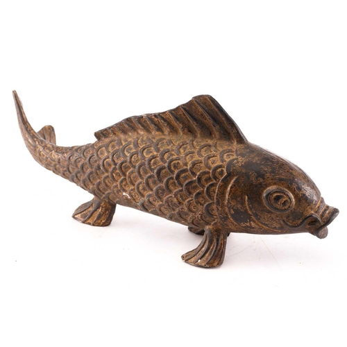 131 - A Chinese bronze carp, the scaley body supported by the pelvis and anal fins, parcel gilt with trace... 