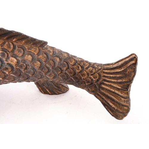 131 - A Chinese bronze carp, the scaley body supported by the pelvis and anal fins, parcel gilt with trace... 