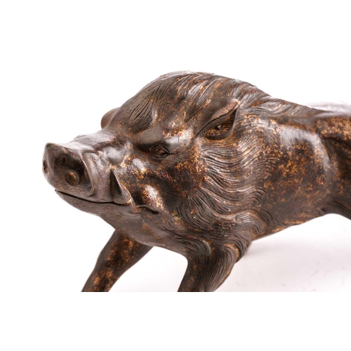 133 - A Chinese bronze figure of a boar, standing on all fours sniffing the air, traces of gilt and red pi... 