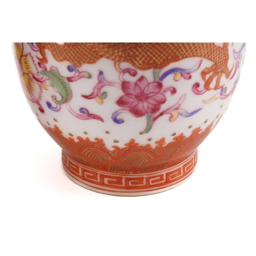 134 - A pair of Chinese porcelain dragon vases, the red dragon highlighted with gilding chasing a flaming ... 