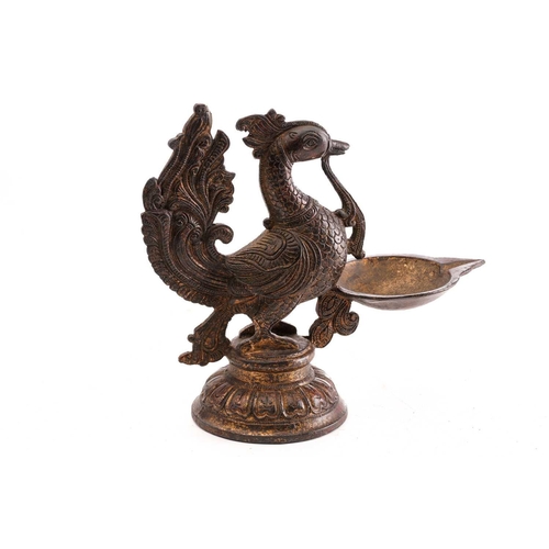 146 - A Chinese bronze model of a South Indian peacock oil lamp, standing on a circular lotus base, traces... 