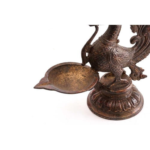 146 - A Chinese bronze model of a South Indian peacock oil lamp, standing on a circular lotus base, traces... 