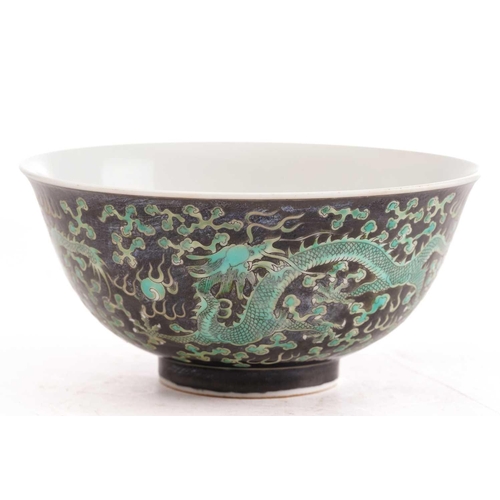 158 - A Chinese porcelain dragon bowl, painted with three dragons chasing a pearl through fiery clouds aga... 