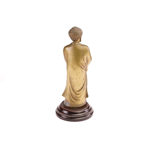 166 - A Chinese cast brass figure of standing Buddha, late Qing, the bearded figure with tight curls and a... 