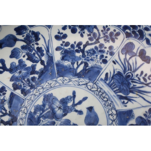 168 - A Chinese blue & white charger, Qing, Kangxi period, the centre painted with flowers within a wanzi ... 