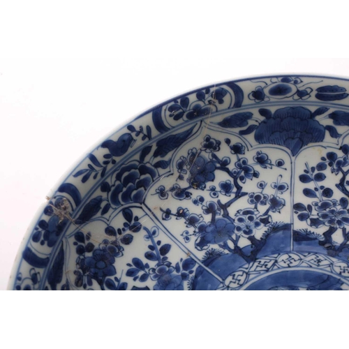 168 - A Chinese blue & white charger, Qing, Kangxi period, the centre painted with flowers within a wanzi ... 