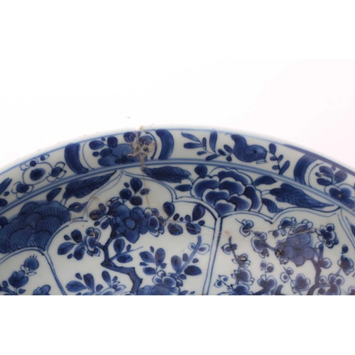 168 - A Chinese blue & white charger, Qing, Kangxi period, the centre painted with flowers within a wanzi ... 