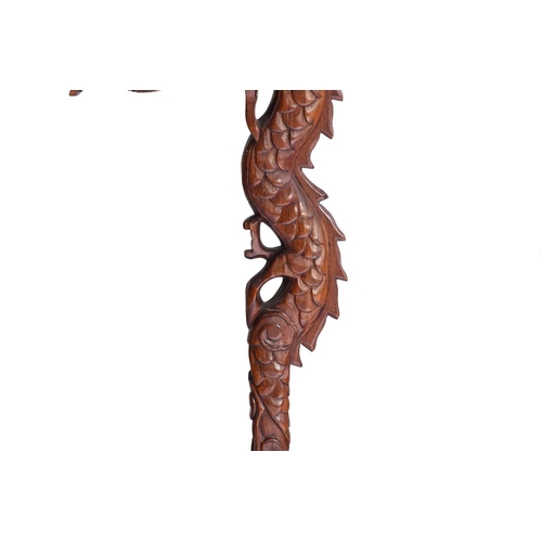 170 - A close pair of Chinese carved wood lantern stands in the form of dragons with turned dome bases and... 