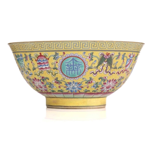 171 - A Chinese porcelain ten thousand blessings bowl, painted with Buddhist symbols on a yellow ground, b... 