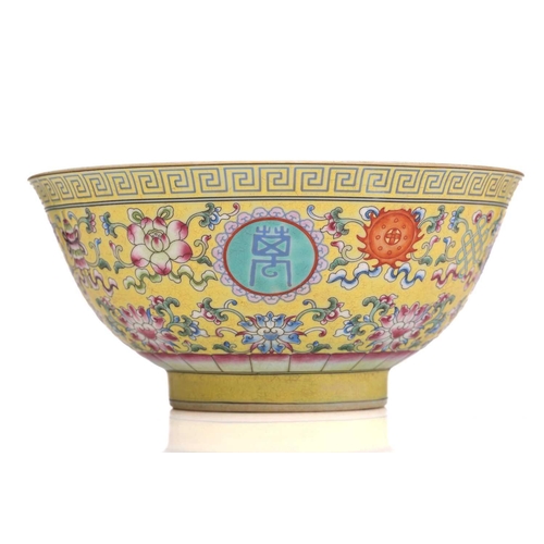 171 - A Chinese porcelain ten thousand blessings bowl, painted with Buddhist symbols on a yellow ground, b... 