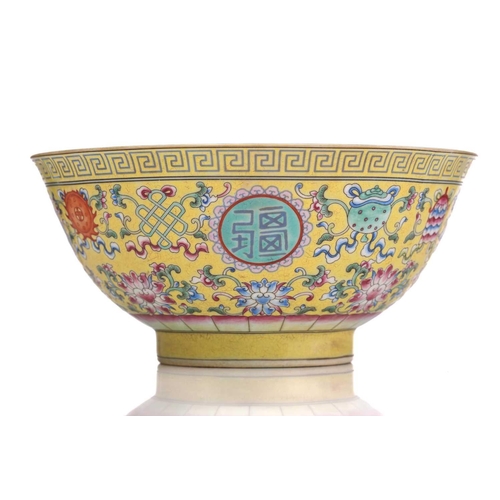 171 - A Chinese porcelain ten thousand blessings bowl, painted with Buddhist symbols on a yellow ground, b... 