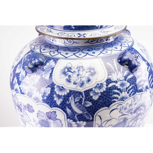 173 - A pair of large Chinese style porcelain vases and covers, the covers with stylised shi shi knops, th... 