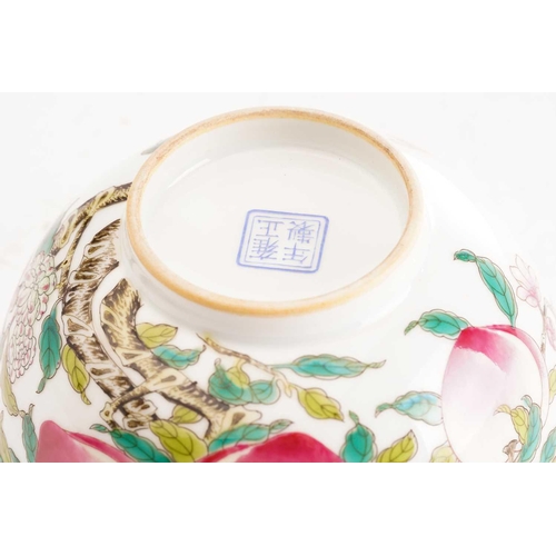 174 - A Chinese porcelain bowl, painted throughout with peaches, blossom and red bats, apocryphal four cha... 