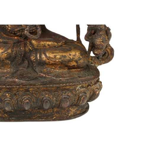 178 - A Chinese Sino Tibetan style bronze Tara, seated in dhyanasana, the six arms with attributes, traces... 