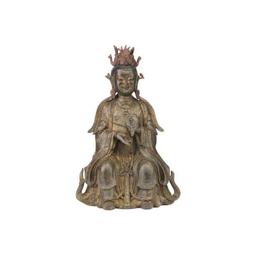 182 - A Chinese bronze figure of Guanyin, seated wearing long robes and holding a mirror, traces of red pi... 