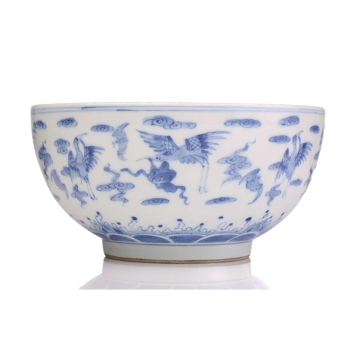 184 - A Chinese porcelain blue & white Cranes bowl, painted with a variety of cranes and bats above spumin... 