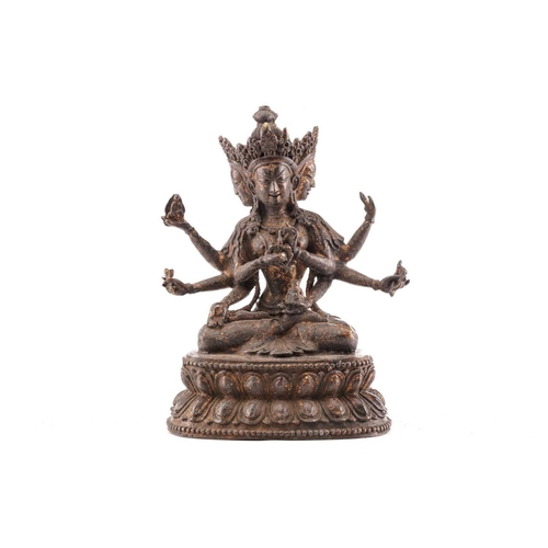 187 - A Chinese bronze figure of Ushnishavijaya, the eight arms each with attribute, beneath three faces, ... 