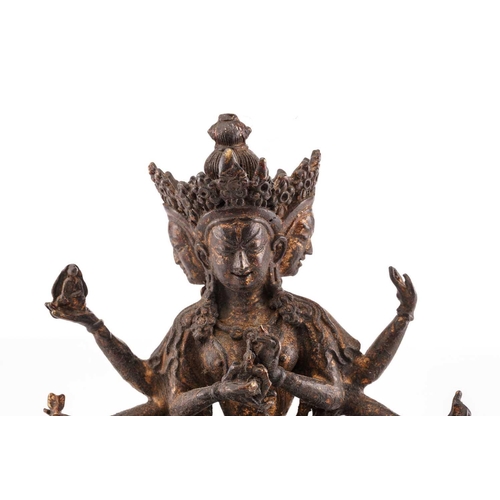 187 - A Chinese bronze figure of Ushnishavijaya, the eight arms each with attribute, beneath three faces, ... 