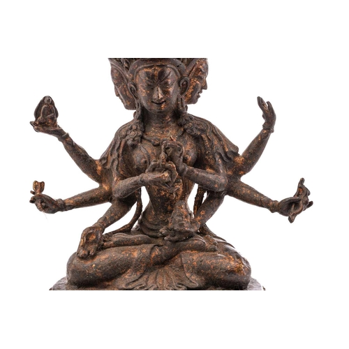 187 - A Chinese bronze figure of Ushnishavijaya, the eight arms each with attribute, beneath three faces, ... 